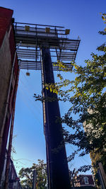 Low angle view of communications tower against clear blue sky