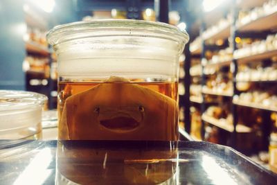 Close-up of beer in glass jar on table at restaurant