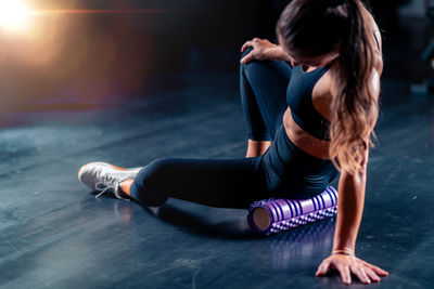 Side view of woman exercising in gym