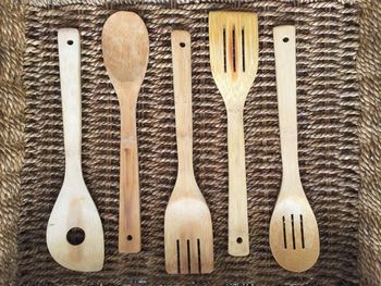 High angle view of wooden spoons in basket