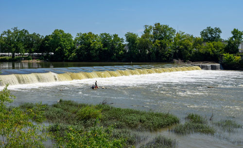 Scenic view of waterfall against sky