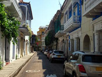 Cars on road amidst buildings in city