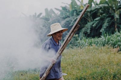 Man with umbrella on field