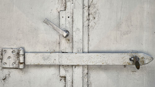 Old white closed door lock detail