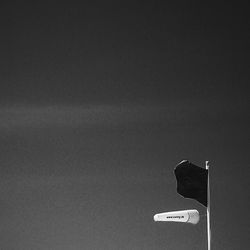 Low angle view of road sign against clear sky