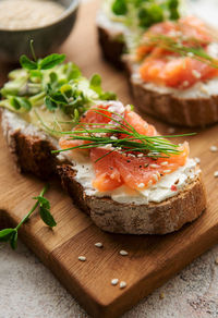 Sandwiches with salted salmon, avocado and microgreens. healthy food.