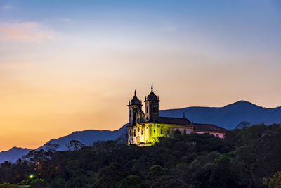 Historic church in baroque style on top of the mountain in ouro preto city during sunset