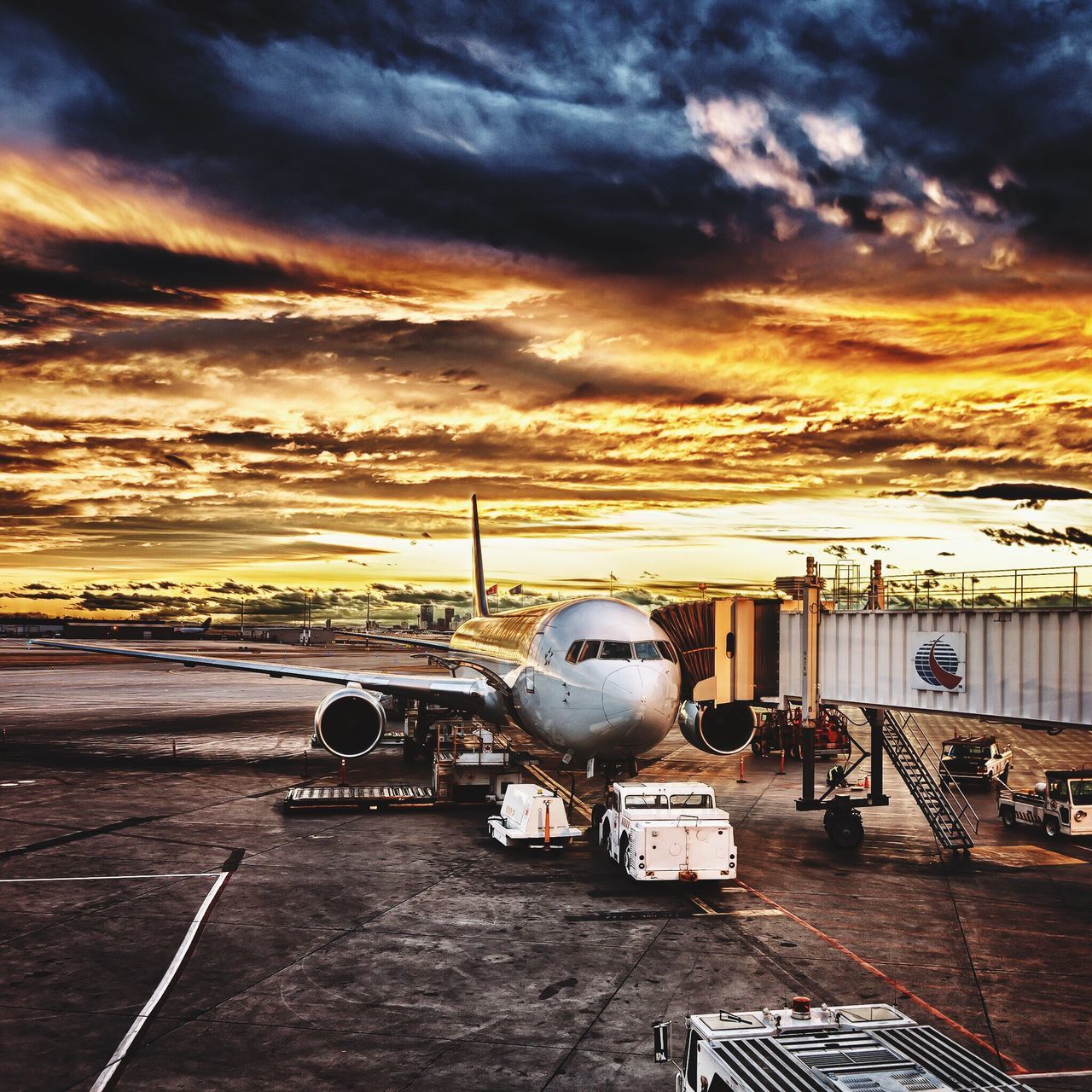 cloud - sky, sky, sunset, mode of transport, cloudy, orange color, weather, cloud, dramatic sky, overcast, airport runway, nature, outdoors, no people, scenics, stationary, landscape, moody sky, beauty in nature, cloudscape, idyllic