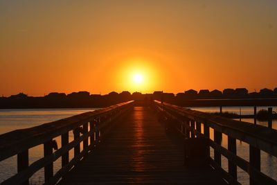 View of pier over sea against sky during sunset