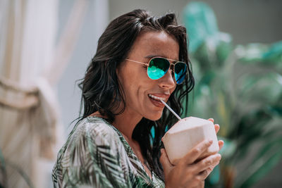 Portrait of a smiling woman holding drink