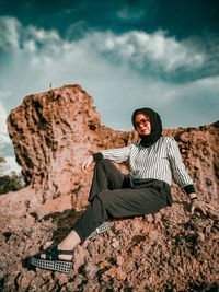 Woman sitting on rock
