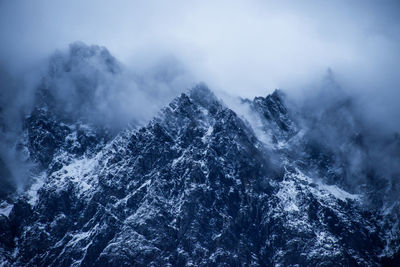 Scenic view of waterfall against sky during winter