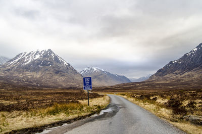 Empty road leading towards mountains