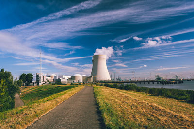 Road by river against sky in city