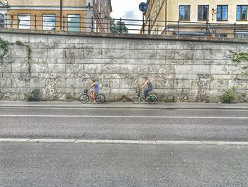 Bicycle parked on road by building