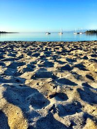 Scenic view of beach against clear sky