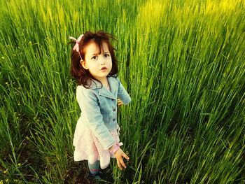 Cute girl standing on field