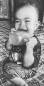 Portrait of boy drinking at home