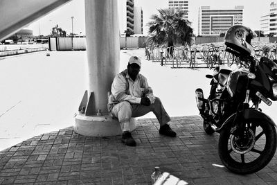 People sitting on street in city