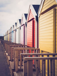 Row of bech huts on norfolk coast close up