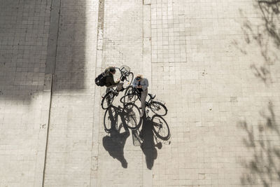 Top view of two people with bikes