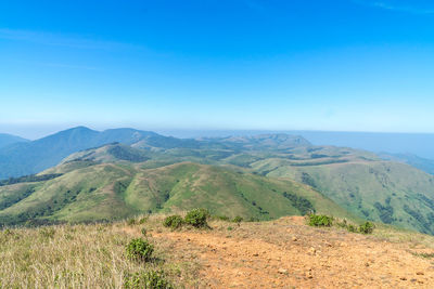 Scenic view of mountains against clear blue sky