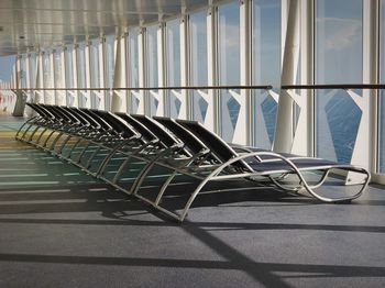 Empty chairs and table by window