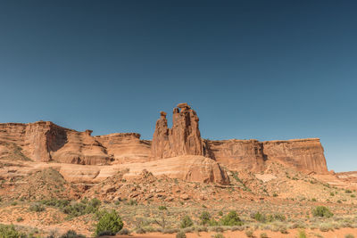 Low angle view of rock formations against blue sky