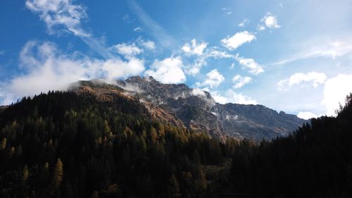 Panoramic view of trees and mountains against sky