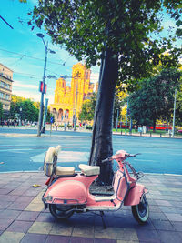 Motor scooter parked on street in city