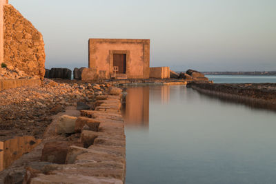 View of sea and buildings against sky