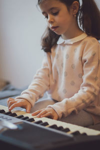 Portrait of young woman playing piano