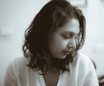 Young woman looking away at home