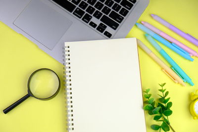 Directly above shot of pencil and book on table