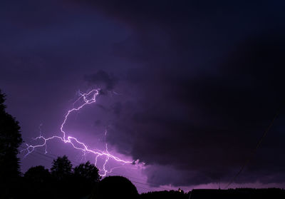 Low angle view of lightning in sky at night