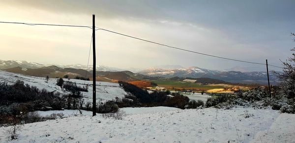 Snow covered landscape against sky