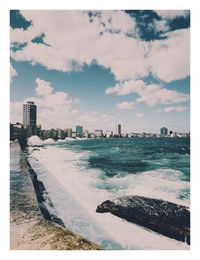 Panoramic view of buildings and city against sky