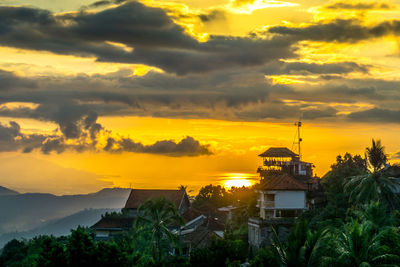 Silhouette buildings against sky during sunset