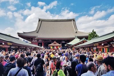 Group of people in temple against sky