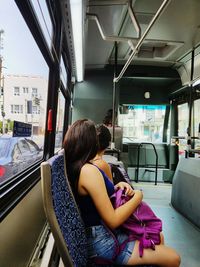 Side view of women sitting in bus