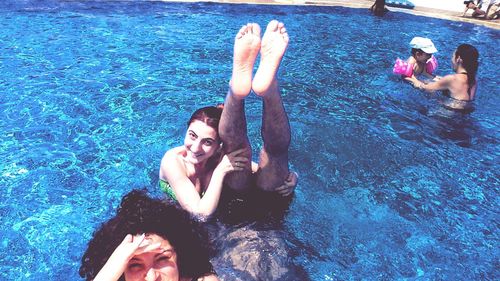 Friends swimming in pool