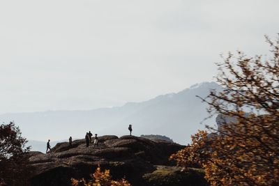 People on mountain against sky