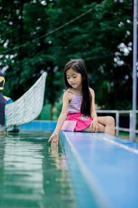 Woman sitting in swimming pool