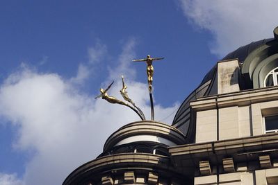 Low angle view of statue against sky in city