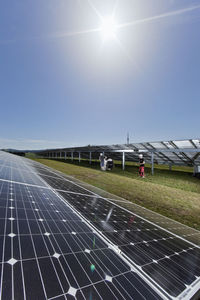 Two worker laying high voltage cable at solar plant