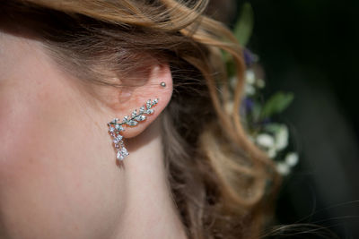 Cropped image of bride wearing diamond earring