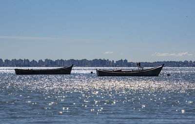 Boat sailing in sea against sky