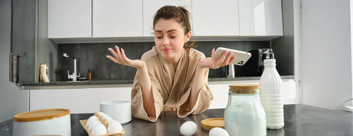 Portrait of young woman working at home