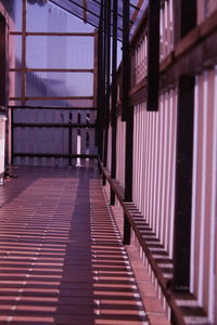 Shadow of railing on building corridor