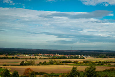 Scenic view of agricultural field against sky